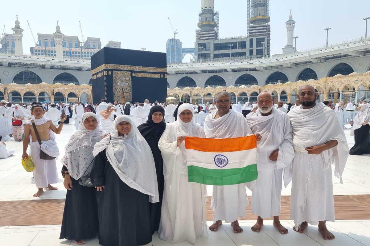 Al Madina pilgrims holding the Indian flag in front of the Kaaba in Makkah